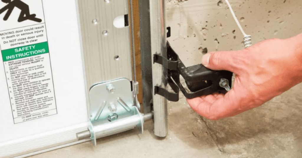 Hand adjusting garage door safety sensor