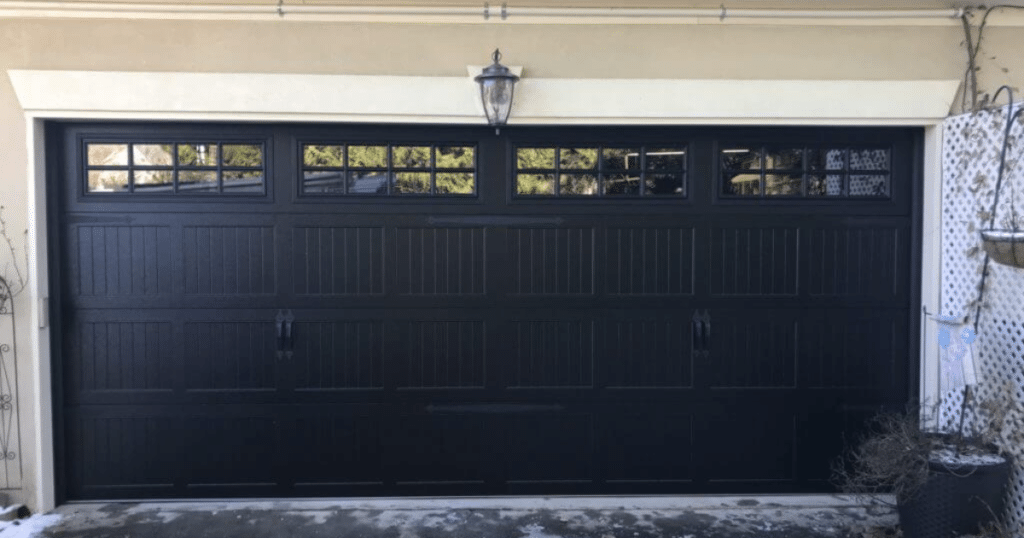 Black garage door with windows and handles