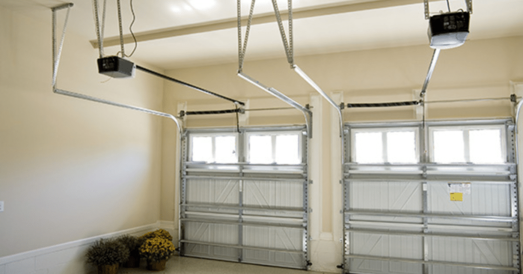 Two closed garage doors with openers above.